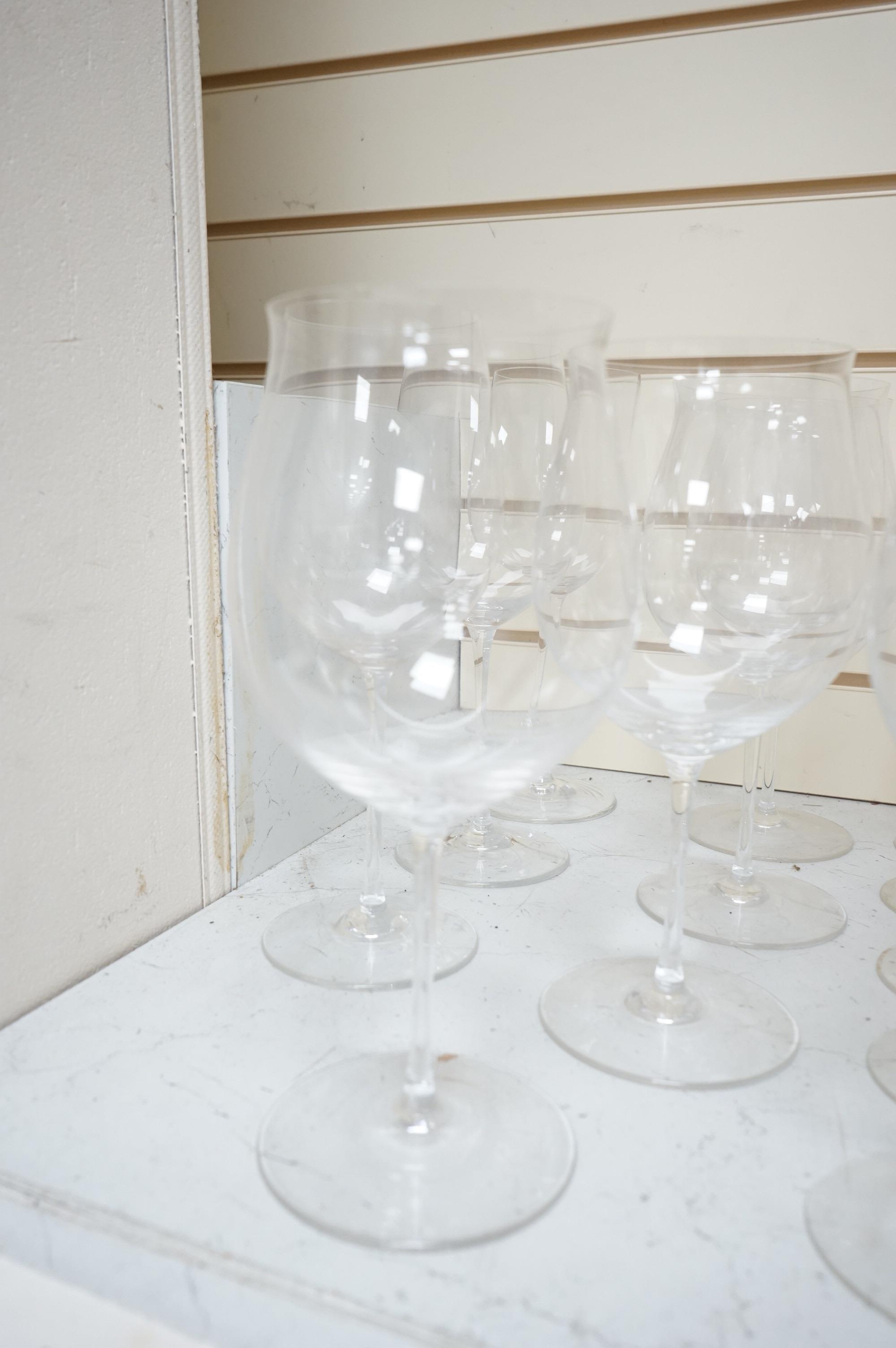 A Pierre Frey ‘Gonesse’ Limoges part dinner service, two Villeroy and Boch ‘Jardins Francais’ dinner plates, with a collection of Riedel wine glasses and mixed Salviati champagne glasses. Villeroy and Boch plates 30.5cm